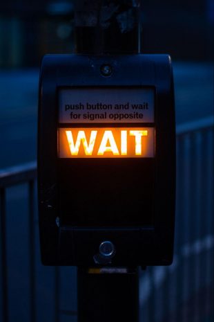 a sign that says wait