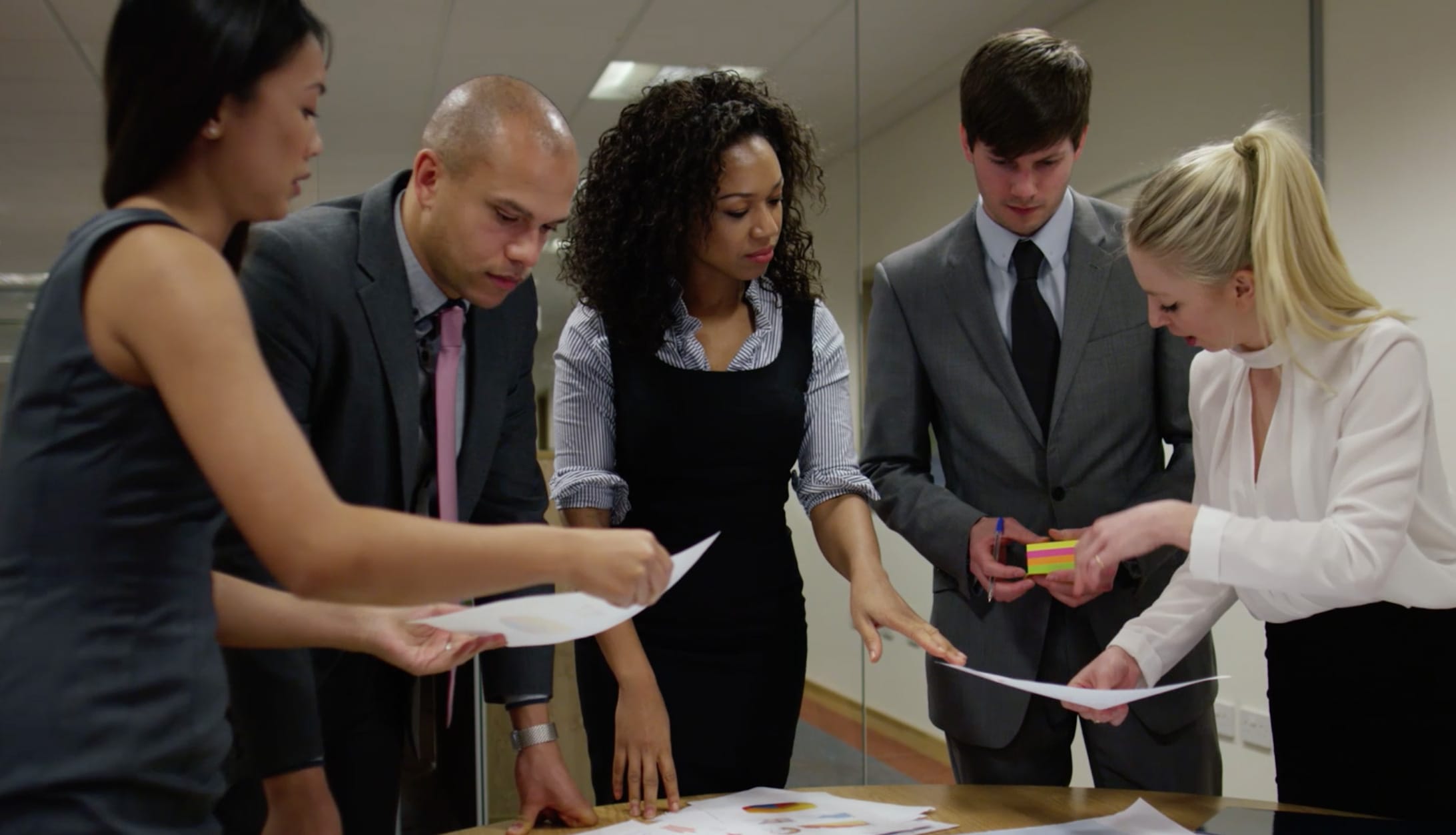 group of business professionals looking at documents